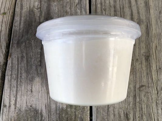 A clear plastic tub of Robie Farm rendered pork lard