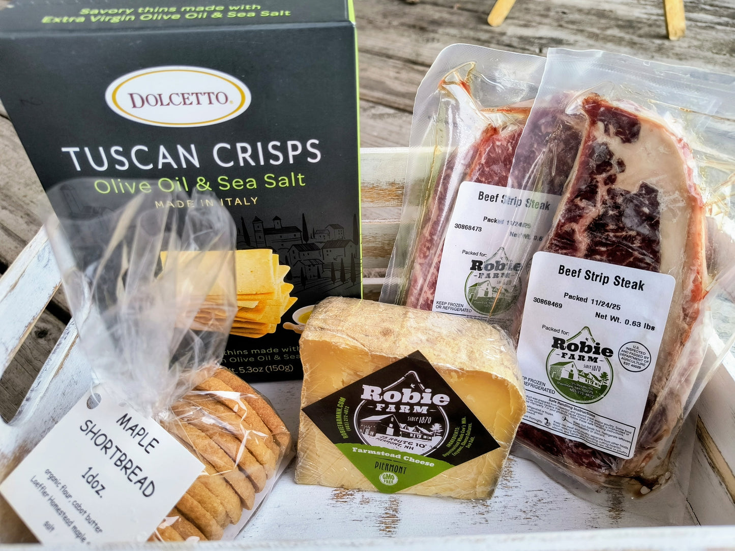 Image of a Valentine's Day Gift Box from the Robie Farm, containing 2 beef strip steaks, crackers, cheese, and maple shortbread cookies