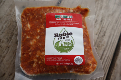 Packaged hot Italian pork sausage from Robbie Farm on a wooden surface