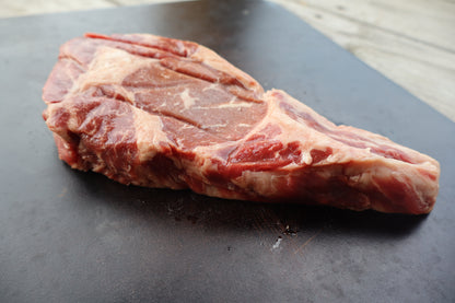 Close up of raw, marbled tender Delmonico steak ready for grilling