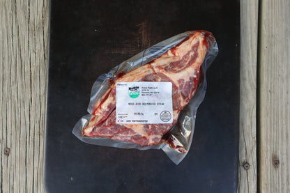 Birdseye view of a vacuum-sealed raw and marbled ribeye steak