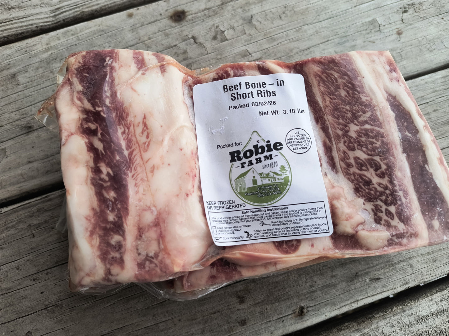 Close up image of a frozen package of Robie Beef bone-in short ribs