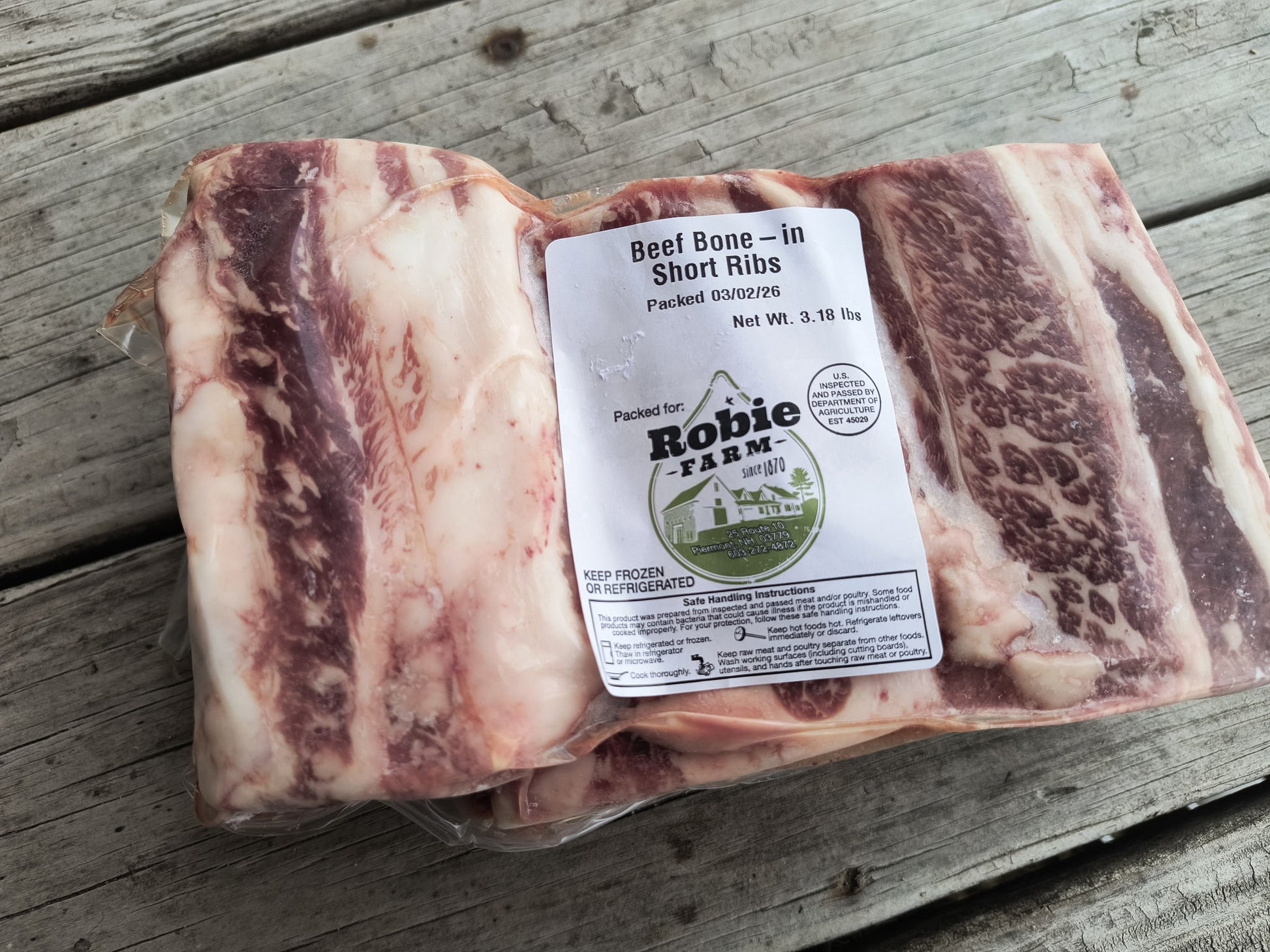 Close up image of a frozen package of Robie Beef bone-in short ribs