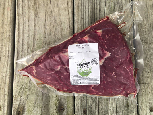 A vacuum-sealed beef coulette steak with a white Robie Farm label