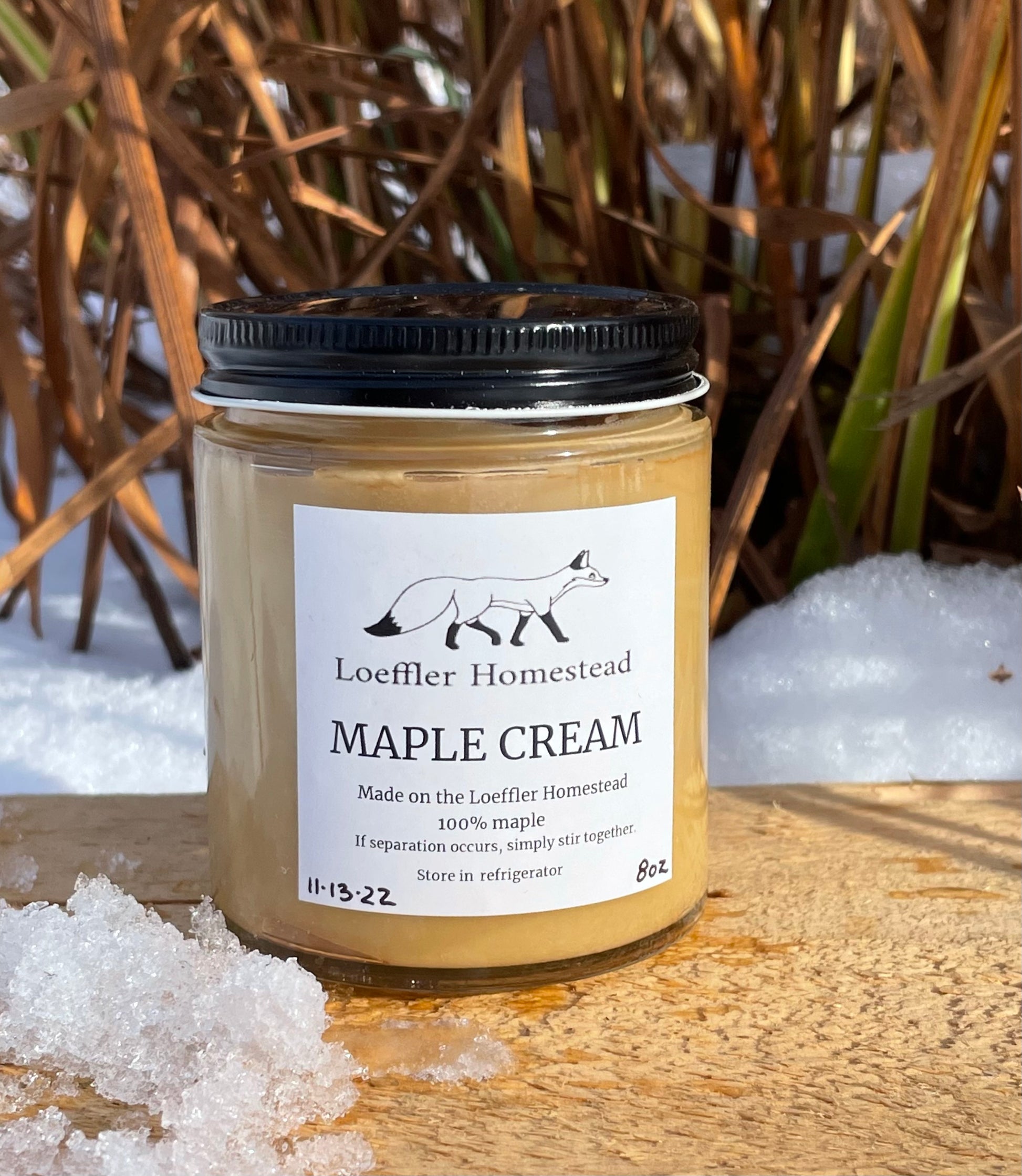 Jar of Loeffler Homestead Maple Cream with a snowy background