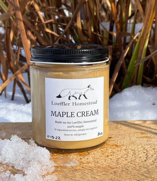 Jar of Loeffler Homestead Maple Cream with a snowy background