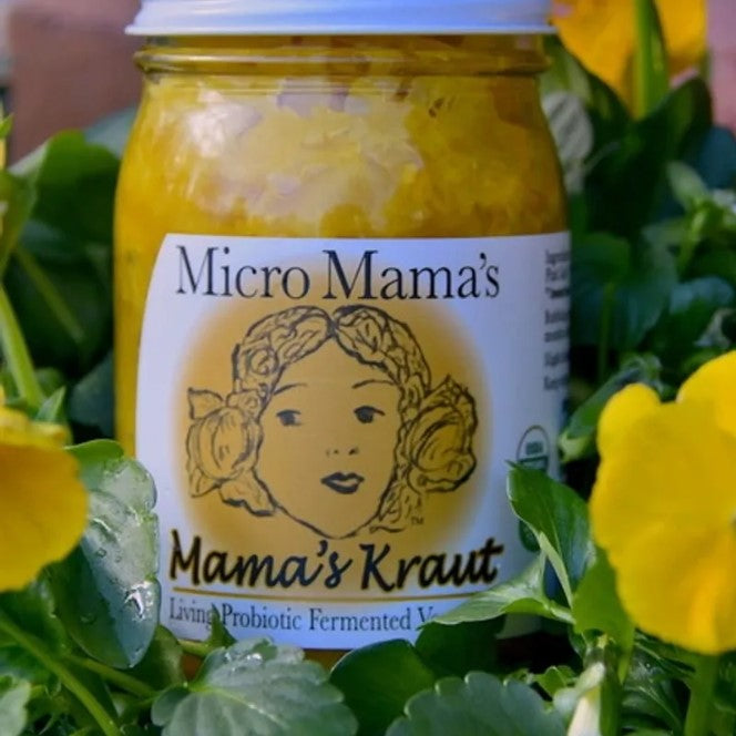 Jar of 'Micro Mama's Mama's Kraut'  surrounded by yellow flowers