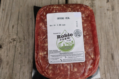 Packaged ground veal from Robie Farm resting on a wooden surface