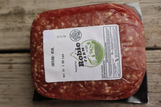 Packaged ground veal resting on a wooden surface