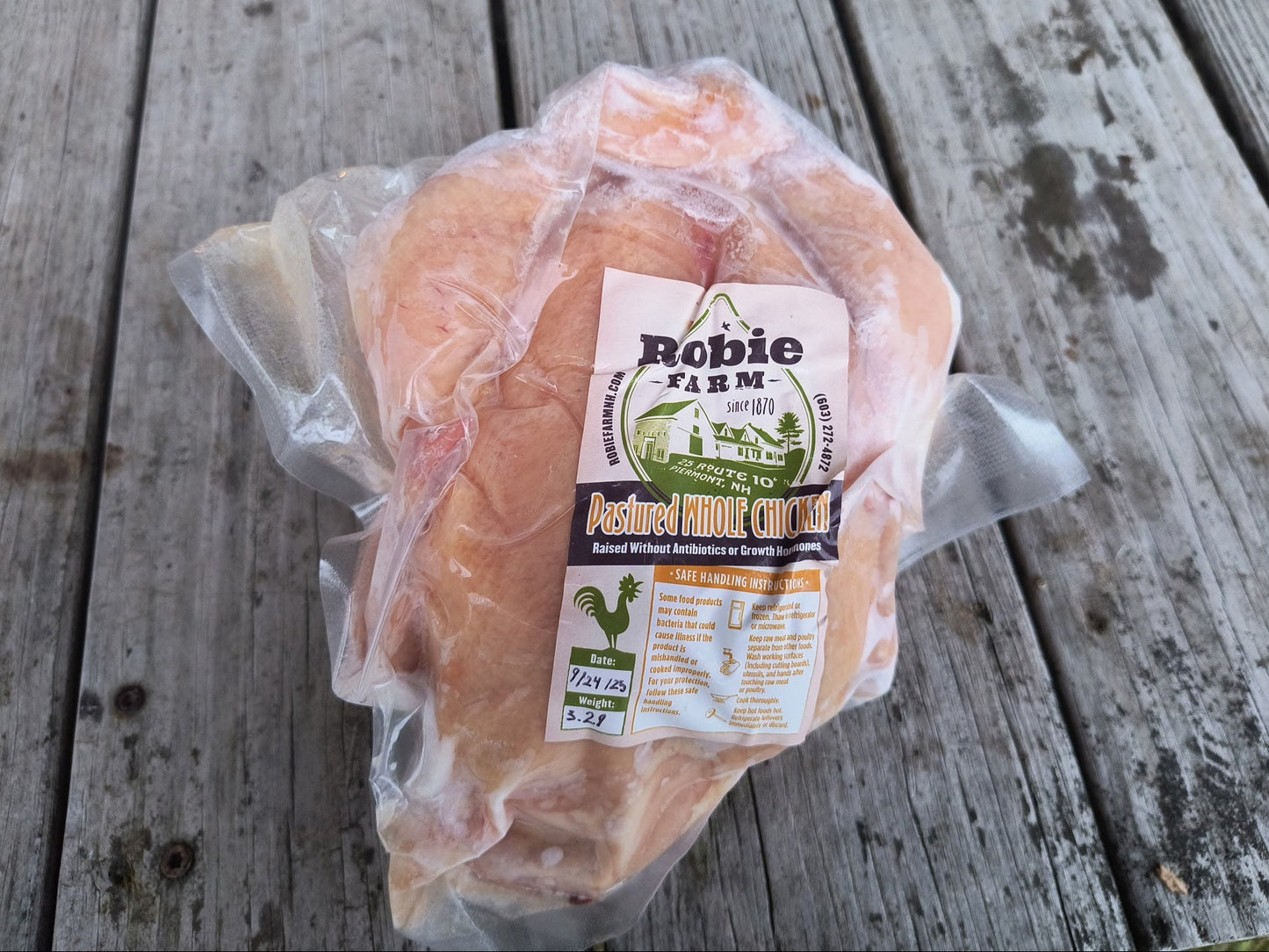 Packaged pastured whole chicken from Robie Farm with a 'Robie Farm' label