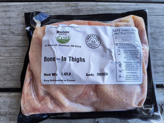 Image of a package of frozen bone-in chicken thighs from Robie Farm in Piermont, NH
