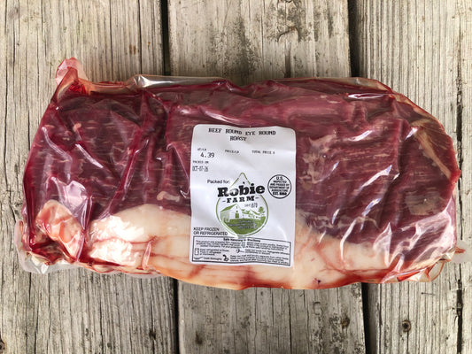 A vacuum sealed frozen package of Robie farm eye round roast 