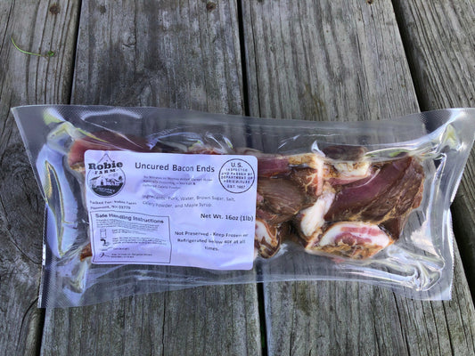 A vacuum-sealed package of Robie Farm Uncured Pork Bacon Ends